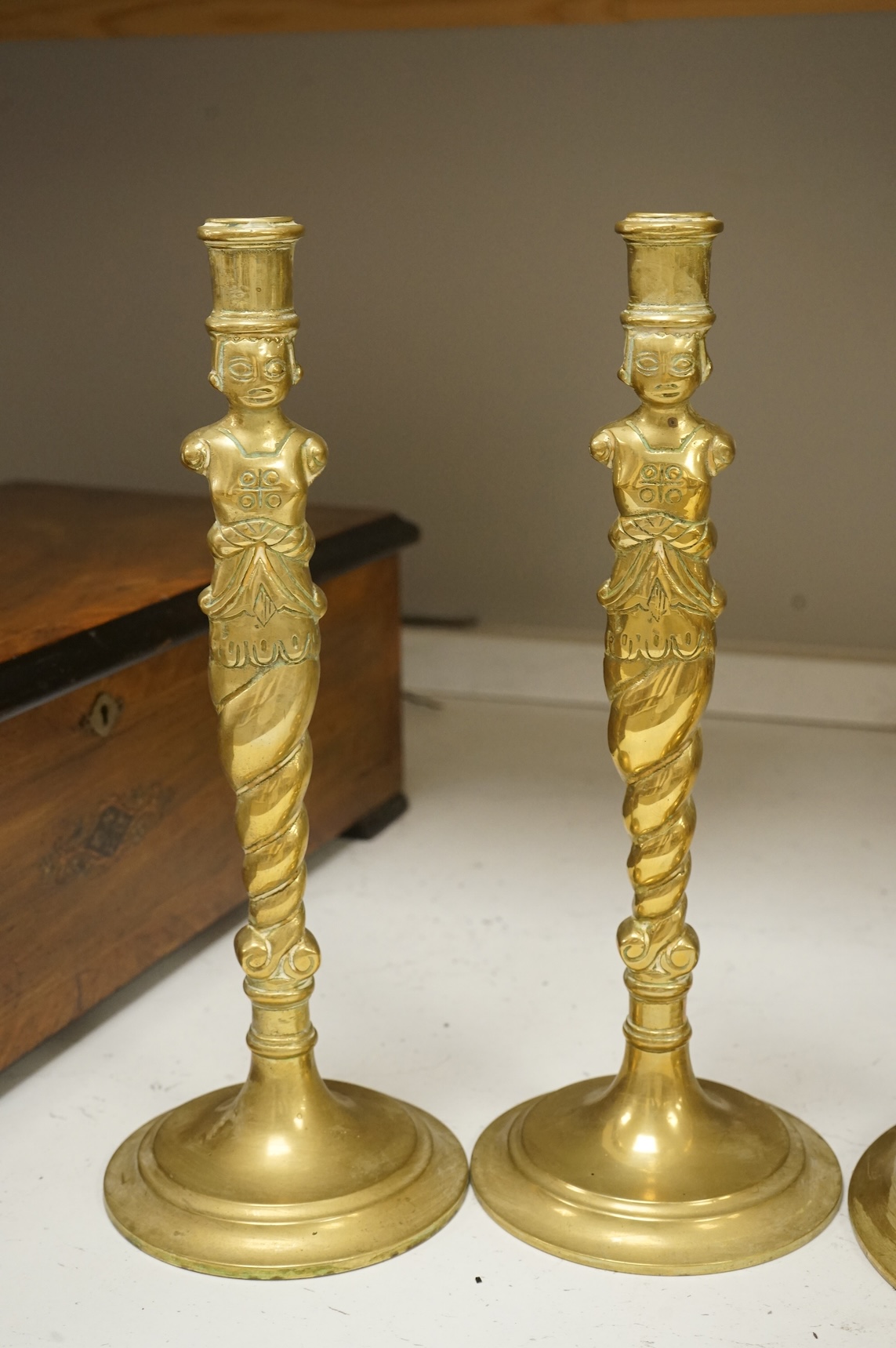 Two pairs of brass candlesticks to include a pair of figural examples, largest 47cm high